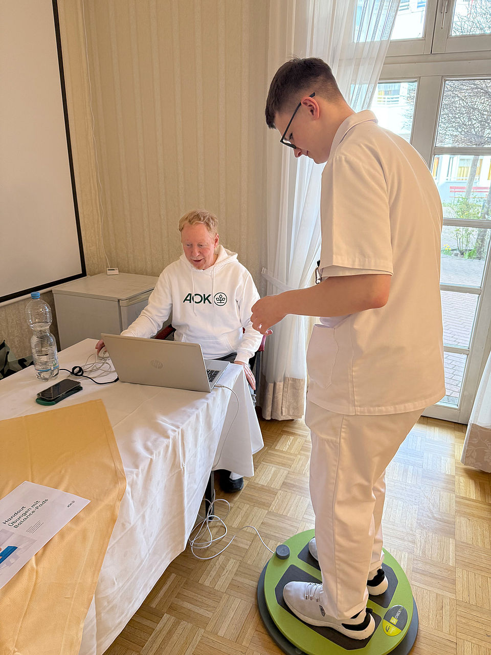 Ein AOK-Mitarbeiter macht Tests mit einem DRK Angestellten